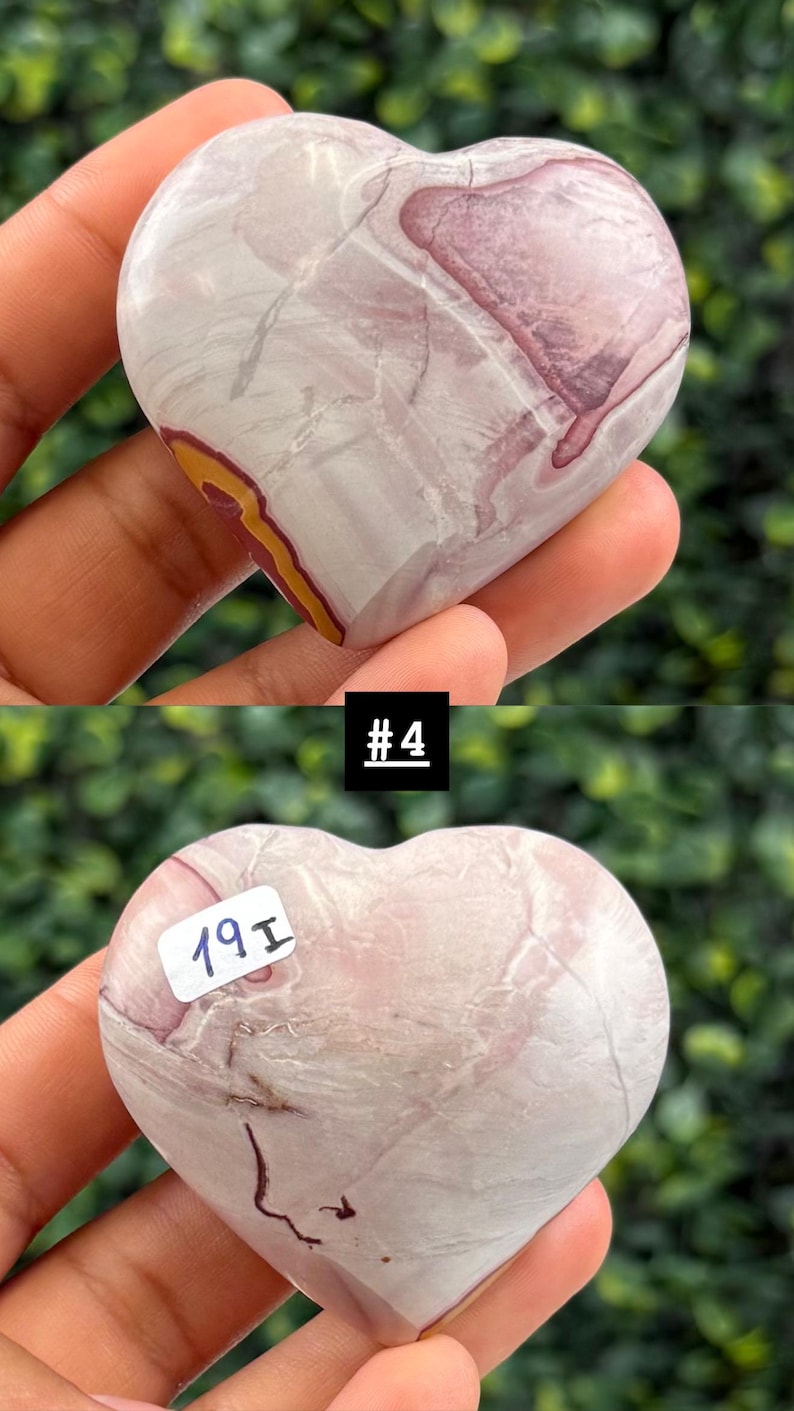 May include: A heart-shaped stone with a mix of pink, white, and yellow hues. The stone has a marbled appearance with a smooth, polished surface. The image includes the text "#4" and a sticker with the text "19I".