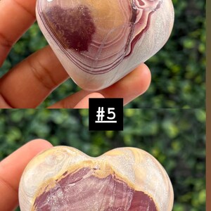 May include: Heart-shaped stone with a mix of colors, including burgundy, tan, and cream. The stone has a polished surface with natural patterns and veining. The top image has the text "23H" on a white sticker. The bottom image has the text "#5" on a black square.