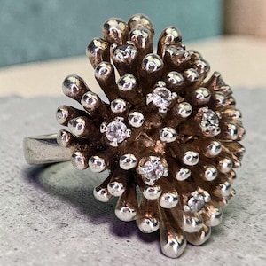 May include: A set of three ceramic mugs with a speckled, matte finish. Each mug features a different color: light blue, cream, and gray. The mugs have a simple, modern design and a comfortable handle.