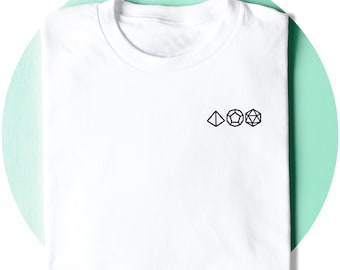 May include: White t-shirt with a crew neck. The shirt features a small black graphic of three geometric shapes: a triangle, a pentagon, and a 20-sided die. The shirt is folded neatly on a light green background.
