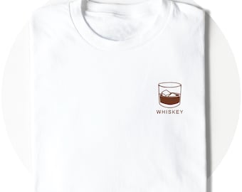 May include: White t-shirt with a brown illustration of a glass of whiskey with ice cubes and the word "WHISKEY" underneath.
