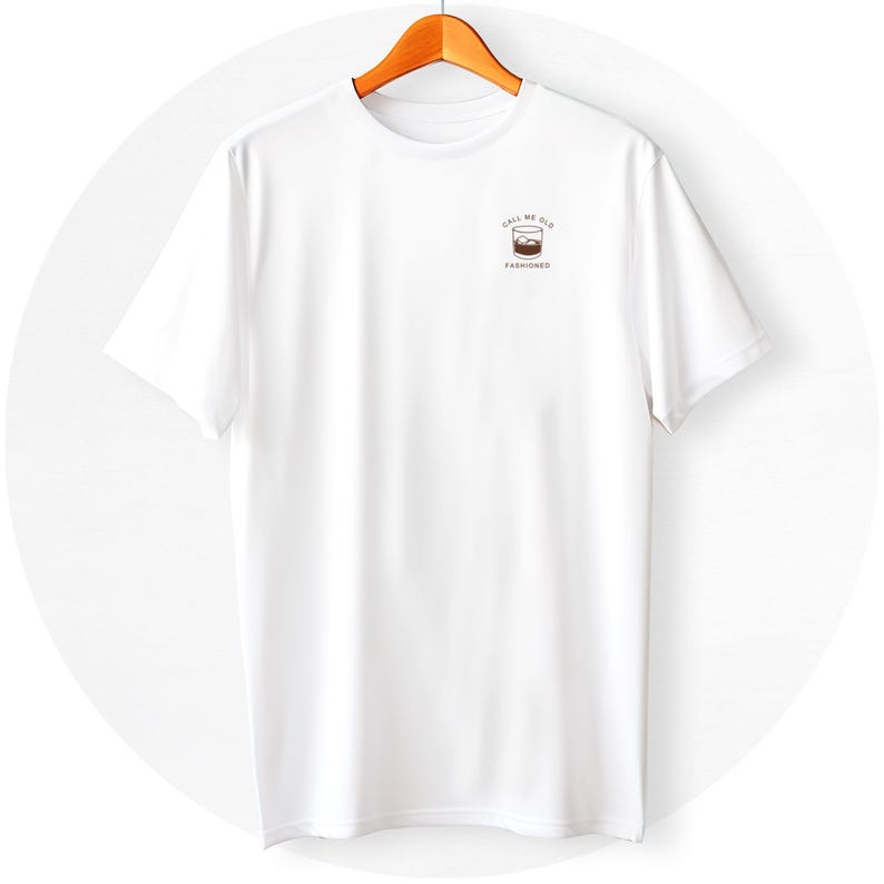 May include: White t-shirt with a small graphic on the left chest that says "Call me old fashioned" with a drawing of a glass of whiskey with ice cubes.