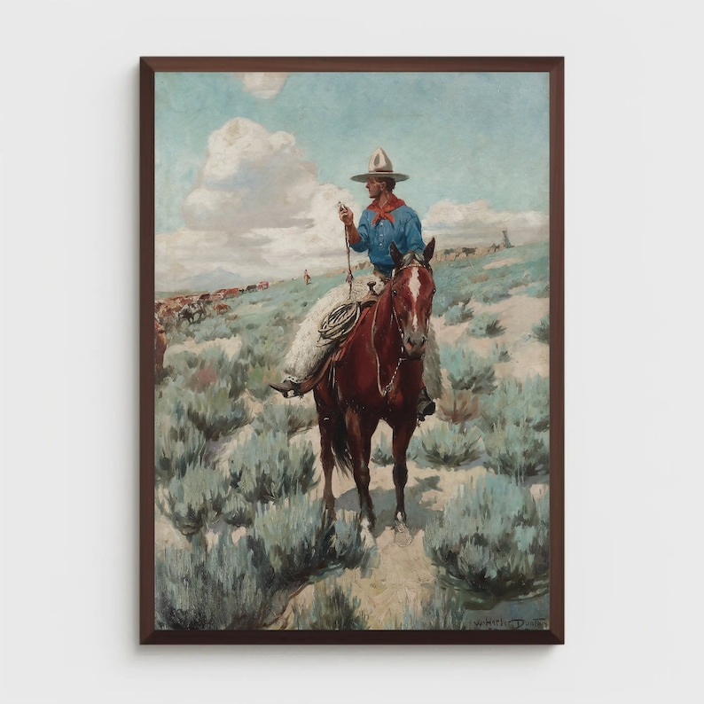 May include: A cowboy in a blue shirt and white hat rides a brown horse through a field of sagebrush. The cowboy is holding a rope in his right hand.