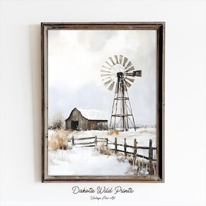 May include: Framed artwork depicting a winter landscape with a barn and windmill. The painting features a rustic wooden fence and tall grass in a snowy field. The artwork is signed "Dakota Wild Prints" and is a vintage fine art piece.