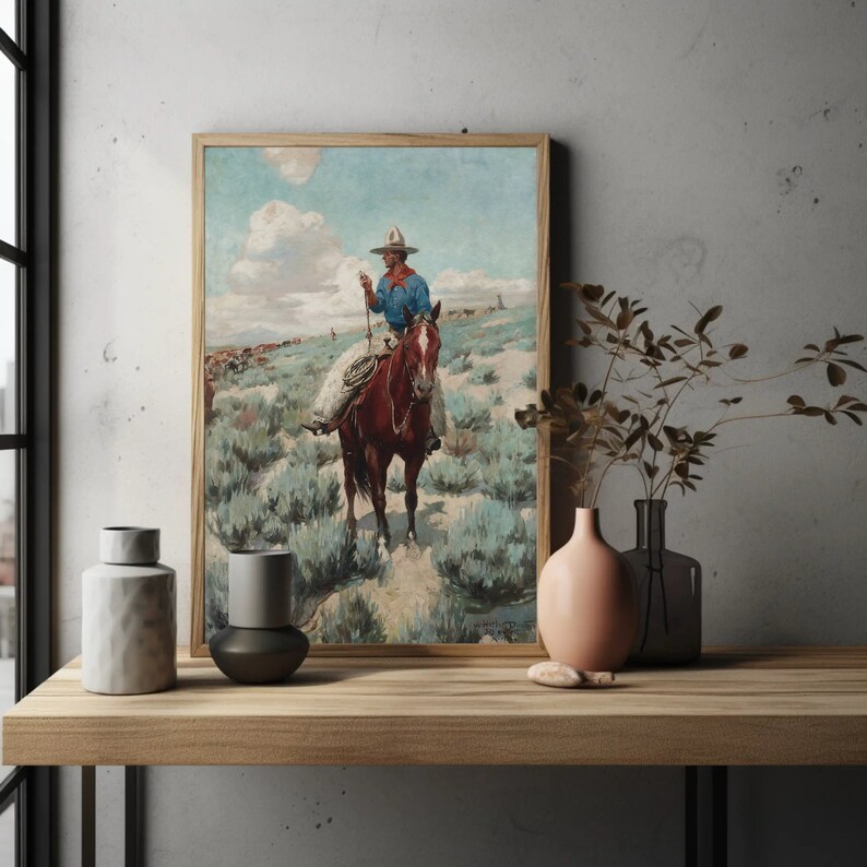 May include: A vintage painting of a cowboy riding a brown horse through a field of sagebrush. The cowboy is wearing a blue shirt, a brown hat, and jeans. The sky is blue with white clouds.