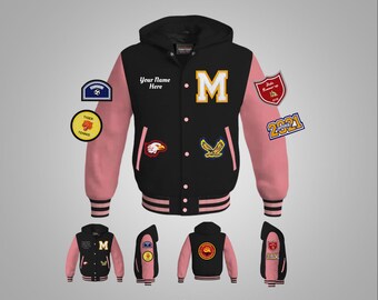 May include: Black and pink varsity jacket with a large letter "M" on the front. The jacket has a hood and several patches, including a soccer ball, a tiger, a tennis racket, and an eagle. The text "Your Name Here" is printed on the jacket. The jacket has a white stripe around the bottom and the sleeves.