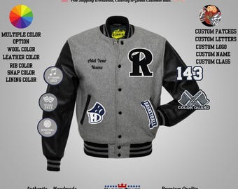 May include: A gray varsity jacket with black leather sleeves, featuring a large black "R" patch and the number "143". The jacket includes custom patches, letters, and a "Basketball" patch. The jacket has a snap closure and a striped rib knit hem.
