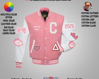May include: Pink and white varsity jacket with the text "Add Your Name" and the number "2026". The jacket has a large white "C" on the front and various patches, including hearts and a bow. The jacket is labeled "Authentic. Handmade."