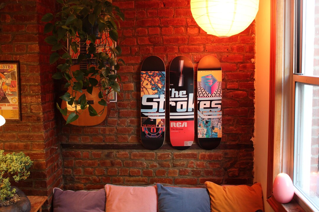 Music-inspired skateboard deck art displayed in horizontal formation
