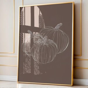 May include: A brown canvas print with a white outline drawing of three pumpkins. The pumpkins are arranged in a cluster, with the largest pumpkin at the top and the two smaller pumpkins below. The background is a solid brown color.