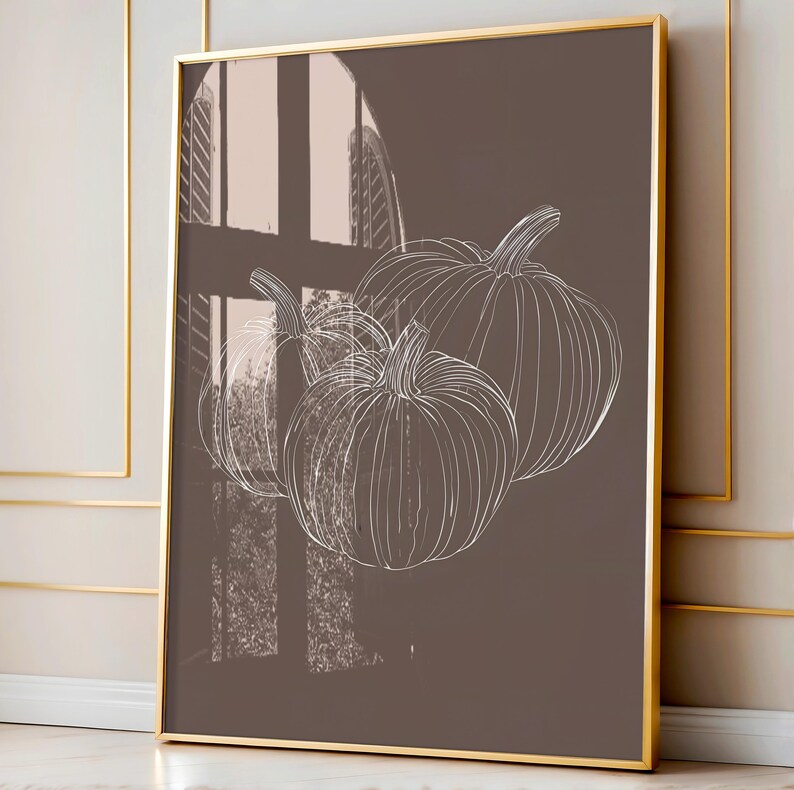 May include: A brown canvas print with a white outline drawing of three pumpkins. The pumpkins are arranged in a cluster, with the largest pumpkin at the top and the two smaller pumpkins below. The background is a solid brown color.