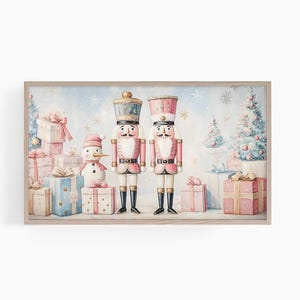May include: A framed watercolor painting of two pink and white nutcracker soldiers standing in front of a snowy winter scene with presents and a snowman.
