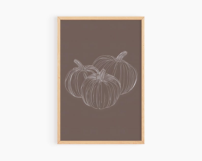 May include: A framed print with a brown background and a white line drawing of three pumpkins.