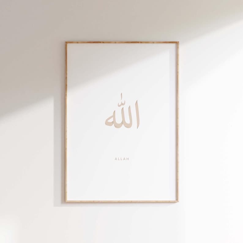 May include: A framed print with a beige background featuring the Arabic word for "Allah" in calligraphy. The word is written in a light brown colour and is centred on the print. The word "Allah" is written in English below the Arabic calligraphy.
