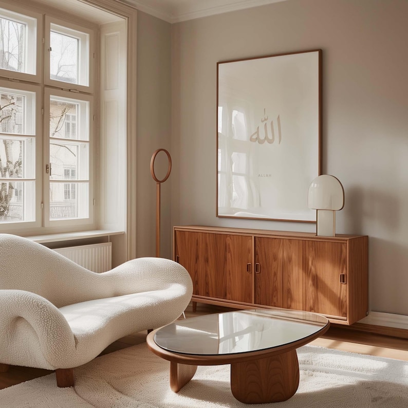 May include: A white sofa with a curved design sits in a living room with a wooden cabinet and a glass coffee table. A framed print with the word "Allah" in Arabic script hangs on the wall.