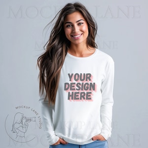 May include: White long-sleeve shirt with a crew neck and the text "YOUR DESIGN HERE" in pink and gray lettering.