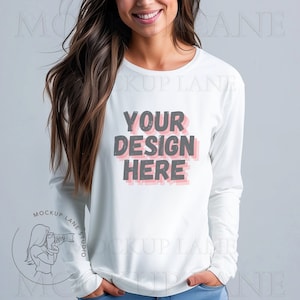 May include: White long-sleeve shirt with a crew neck and the text "YOUR DESIGN HERE" in gray and pink.