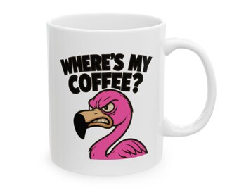 May include: White ceramic coffee mug with a black handle. The mug features the text "WHERE'S MY COFFEE?" above a cartoon flamingo with an angry expression. The flamingo is pink with a black beak.
