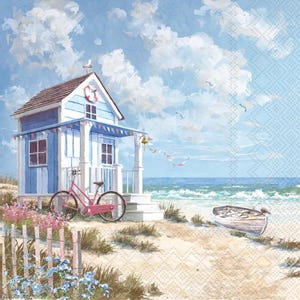 May include: A decorative paper napkin featuring a coastal scene with a light blue and white beach hut, a pink bicycle parked in front, a small wooden rowboat on the sand, and a bright blue sky with fluffy white clouds above the ocean.
