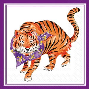 May include: Watercolor illustration of an orange tiger with black stripes, wearing a purple scarf with gold fleur-de-lis designs. The tiger is set against a white background with a subtle pattern, framed by a purple border.