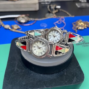 Vintage silver tone watches with colorful enamel inlay bands.