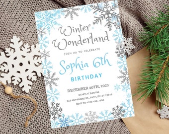 May include: A white invitation with a blue and gray snowflake border. The text reads "Winter Wonderland" with a blue "Sophia 6th Birthday" underneath. The invitation includes the date, time, and location of the event.
