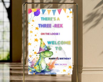 May include: A colorful birthday party sign, 24" x 36", with a watercolor illustration of a dinosaur wearing a party hat. The sign reads "THERE'S A THREE-REX ON THE LOOSE! WELCOME TO HARRY'S BIRTHDAY NOV, 24, 2025". Gold frame.