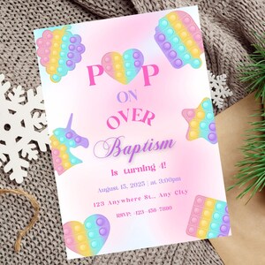 May include: A pink and white invitation with a pop-it theme. The invitation says "Pop On Over Baptism is turning 4!" with a date and time. The invitation is decorated with colorful pop-it toys.