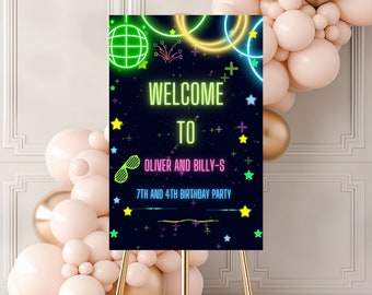May include: Neon green, yellow, and pink welcome sign with a disco ball, stars, and plus signs on a black background. The sign says "Welcome to Oliver and Billy-S 7th and 4th Birthday Party".