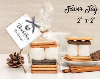 May include: A clear cellophane bag filled with graham crackers, marshmallows, and chocolate. A tag with the text "Thank You For Coming!" is attached with a gray ribbon. The tag is 2 x 2 inches.