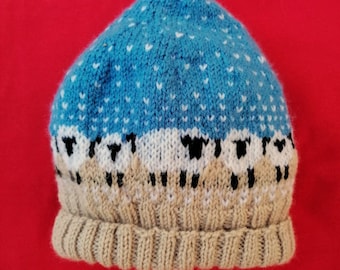 Bonnet enfant jacquard moutons sous la neige