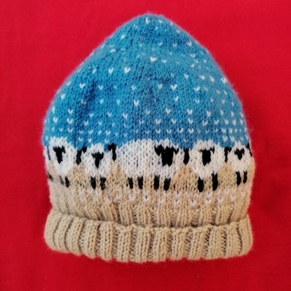 Bonnet enfant jacquard moutons sous la neige