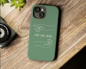 May include: A green phone case with a white outline of two hands reaching towards each other. The text "LOVE LIKE JESUS" is printed in white on the case.