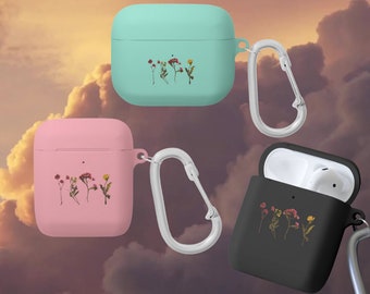 May include: Three different colored Airpod cases with a floral design and a carabiner clip. The cases are light blue, pink, and black.