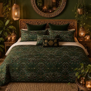 May include: A bed featuring a dark green duvet cover with a dense, multi-colored floral pattern. The bedding includes two large rectangular pillows, two smaller rectangular pillows, and one central lumbar pillow with gold floral embroidery.