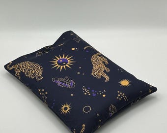 May include: A navy blue pillow with a celestial and animal print. The design includes gold tigers, suns, stars, and a purple spaceship. The pillow is rectangular and has a soft, plush appearance.