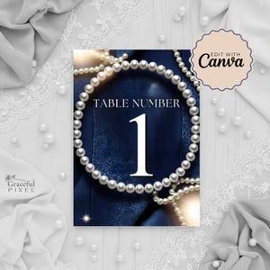 May include: A navy blue table number card with a pearl necklace border. The card features the text "TABLE NUMBER 1" in white. The image also includes the text "EDIT WITH Canva" and "Graceful Pixel".