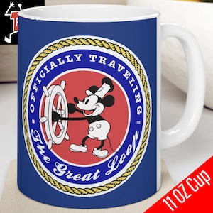 May include: A blue ceramic mug with a white handle features a red, white, and blue circular design with a rope border. The design includes a cartoon image of Mickey Mouse wearing a captain's hat and steering a ship's wheel. The text "Officially Traveling The Great Loop" is written around the design.