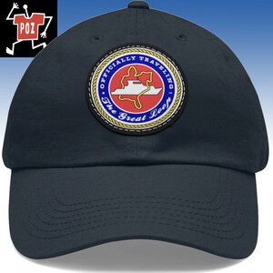 May include: A navy blue baseball cap with a circular patch that says "Officially Traveling The Great Loop". The patch features a red and white boat on a blue and white map.