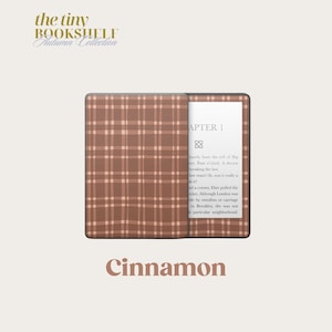 May include: A brown and white plaid Kindle Paperwhite e-reader cover with the text "Cinnamon" printed below. The cover is part of a collection called "The Tiny Bookshelf Autumn Collection".