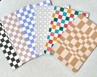 May include: Six different patterned cards with a checkered design. The cards are in various colors, including black, white, brown, purple, pink, orange, green, and blue.