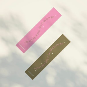 May include: Two bookmark designs with a pink and a brown background. The text on both bookmarks reads "Tell me I'm pretty & buy me books".