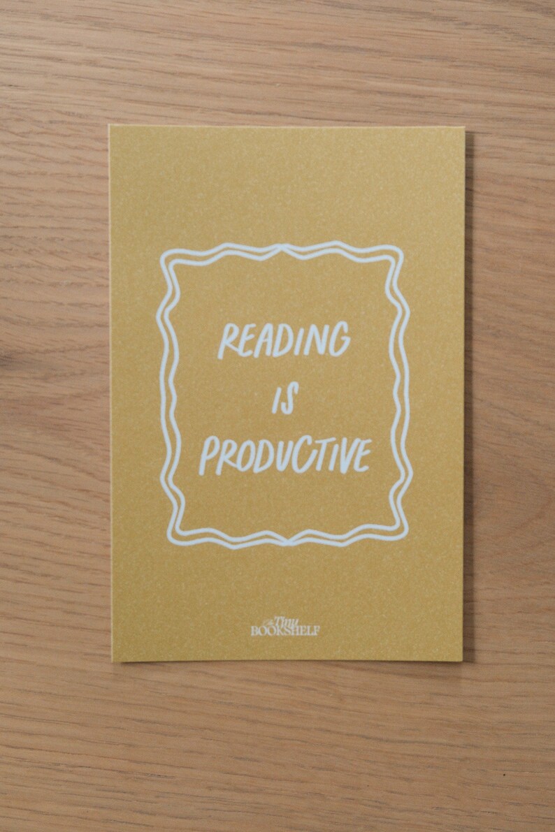 May include: A yellow card with a white border and the text "Reading is Productive" inside. The text "Tiny Bookshelf" is at the bottom of the card.
