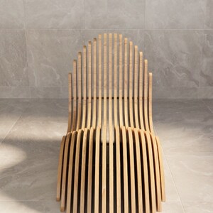 May include: A wooden chair with a curved back and seat made of thin, vertical slats. The chair is light brown and has a simple, modern design.