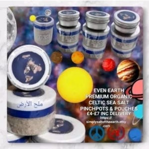 May include: Three glass jars with lids containing Celtic sea salt. The jars are labelled "Even Earth Premium Organic Celtic Sea Salt" and "Salt of the Earth". The jars are surrounded by images of planets and stars.