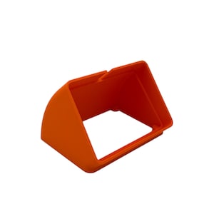 May include: A bright orange, rigid plastic monitor hood with a rectangular frame and a curved top section. The accessory features a hollow center and a smooth, matte finish, designed to attach to a screen to reduce glare and improve visibility.