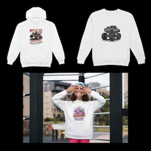 May include: Three white sweatshirts and hoodies with monster truck graphics. One hoodie has the text "MONSTER TRUCK ROARING BEAST UNLEASH THE POWER". Another sweatshirt features a monster truck design. A girl is wearing a hoodie with "GIRL POWER MONSTER" text.