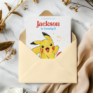 May include: A yellow Pikachu cartoon character with a red heart on a white background. The text "I choose you" is at the top of the card. The text "Jackson is turning 3" is below the character.