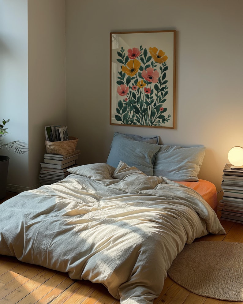 A dark moody bedroom with a floor bed. A large wood oak frame in on the wall above the bed.