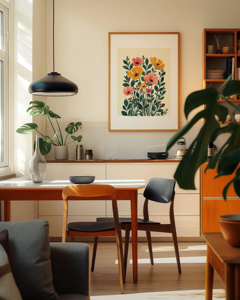 A cosy corner of a neutral wood kitchen with sunlight streaming in. A large framed artwork in on the wall